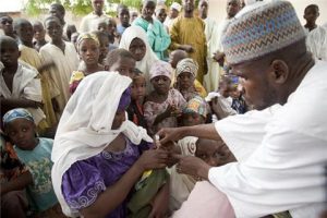 In June 2010 a child receives a oral polio vaccine during the polio campaign in the Kabuga locality of Kano city, Nigeria. Global Health Strategies