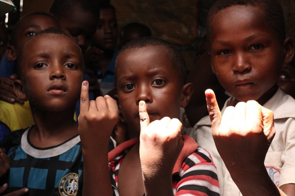 Children in Somalia show their ink stained fingers that show they have received a dose of the oral polio vaccine. 