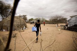 A community health worker goes door-to-door to vaccinate children during a measles and polio immunization campaign in the town of Dadaab. Siegfried Modola/UNICEF