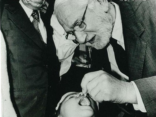 Debbe's father, Albert Sabin, administers his creation - oral polio vaccine - to a child. WHO/Pasteur Merieux