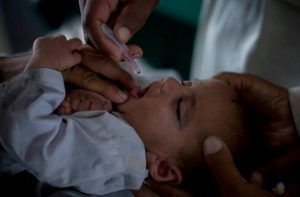 Families and children fleeing the military operations in North Wazirstan receive polio drops at roadside vaccination points, June 24, 2014. © UNICEF/Mian Khursheed