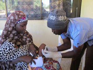 A child in Nigeria is given a dose of the inactivated polio vaccine, helping to protect them against all strains of poliovirus. Nigeria introduced the vaccine in February 2015, the first of the polio-endemic countries to do so. UNICEF