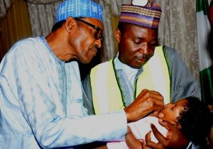President Buhari gives his three-month-old granddaughter the oral polio vaccine to mark one year since the last case was confirmed in Nigeria. High level political commitment has been crucial for progress so far. © Government of Nigeria