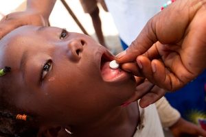 A girl receives de-worming tablets. Azuretti Fishing Village, Cote d'Ivoire. © Rotary International