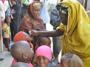 Children being immunized in a school yard. WHO/R.Curtis