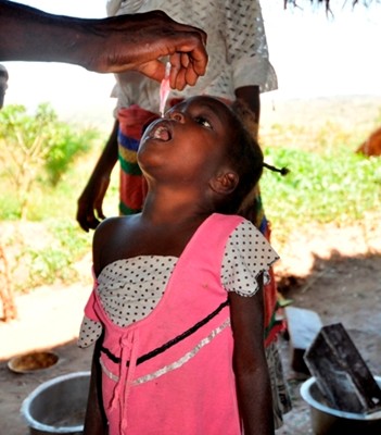 A girl receiving oral polio vaccine.