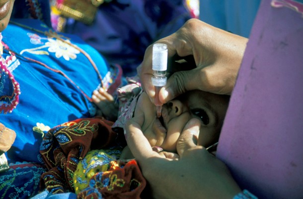 A child receives the oral polio vaccine during a National Immunization Day in Pakistan 