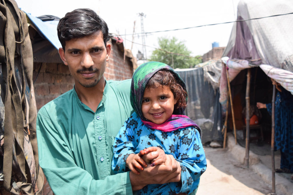 A father posing with his daughter after getting her vaccinated in Lahore, Pakistan. May 2017. ©WHO EMRO / Anam Khan