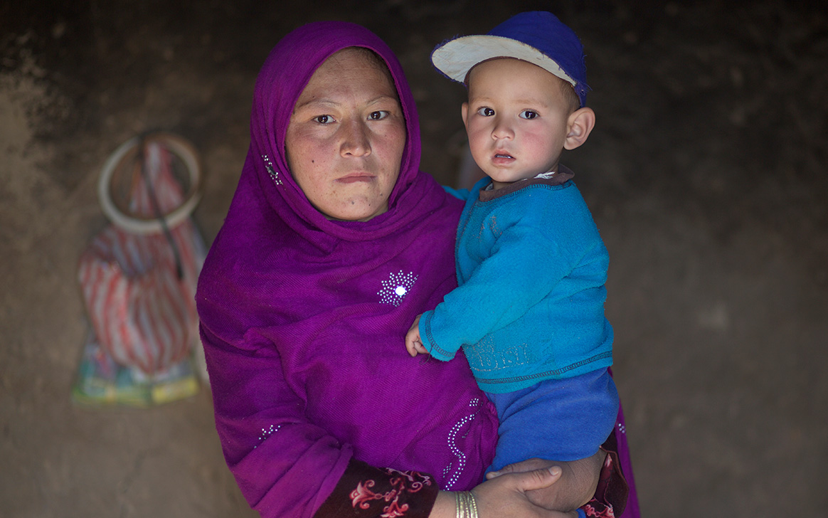 Roqia holds her young son, who was reported through the local surveillance network in Bamyan, Afghanistan, as having acute flaccid paralysis. ©WHO Afghanistan