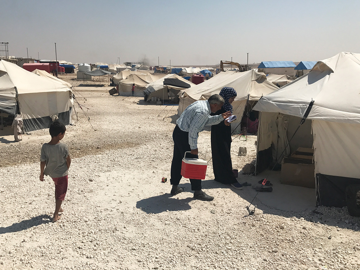 Vaccination volunteers go tent to tent in a Syrian camp for internally displaced families, immunizing each child against polio. Some of these volunteers are also trained in surveillance, able to identify and report any child suffering from paralysis. ©WHO Syria