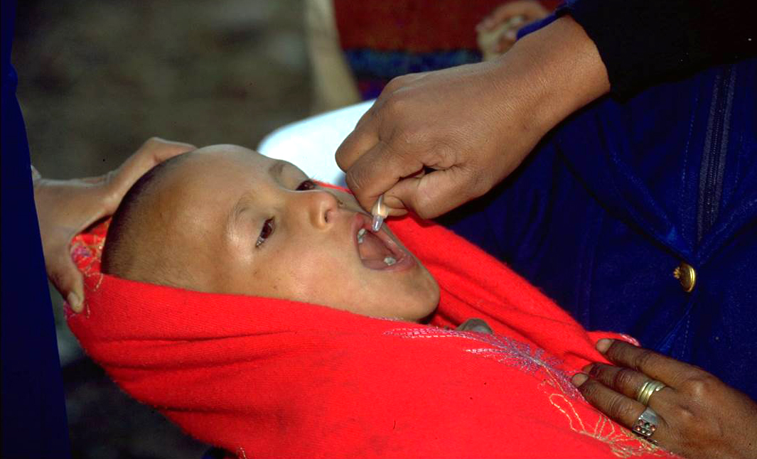 A child is protected from lifelong polio paralysis through OPV vaccination. © WHO