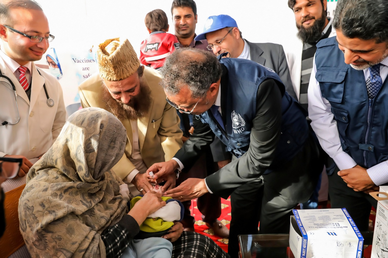Dr Tedros Adhanom Ghebreysus, WHO Director General and Chair Polio Oversight Board, administering polio drops to a young child in Pakistan. WHO/Jinni