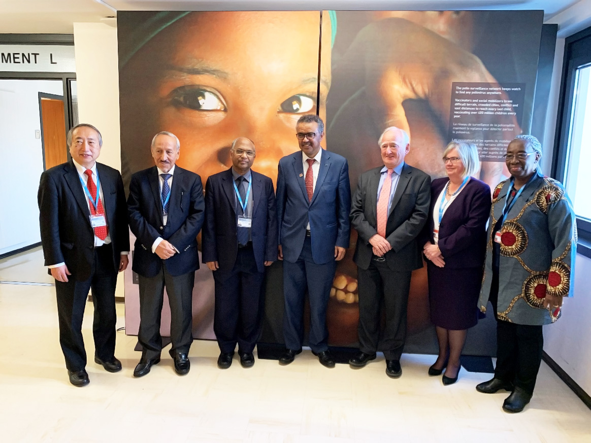 27 February 2019, WHO, Geneva, Switzerland – WHO Director-General Dr Tedros Adhanom Ghebreyesus (centre) with members of the GCC (from left to right):  Dr Nobuhiko Okabe (Chair of Western Pacific RCC), Professor Yagoub Al-Mazrou (Chair of Eastern Mediterranean RCC), Professor Mahmudur Rahman (Chair of South-East Asian RCC), Professor David Salisbury (Chair of GCC and Chair of European RCC), Dr Arlene King (Chair of American RCC, and Chair of the GCC Containment Working Group); and, Professor Rose Leke (Chair of African RCC). © WHO