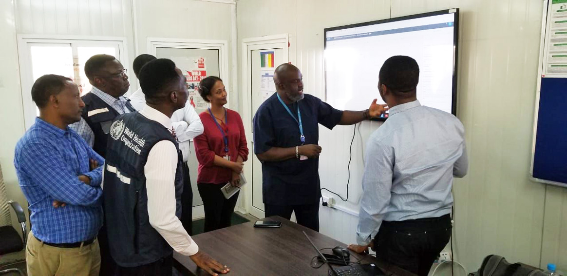 WHO Representative and Polio Team Lead with colleagues in Juba, South Sudan, interacting with the data streaming on the real-time dashboards. ©WHO/Sudan