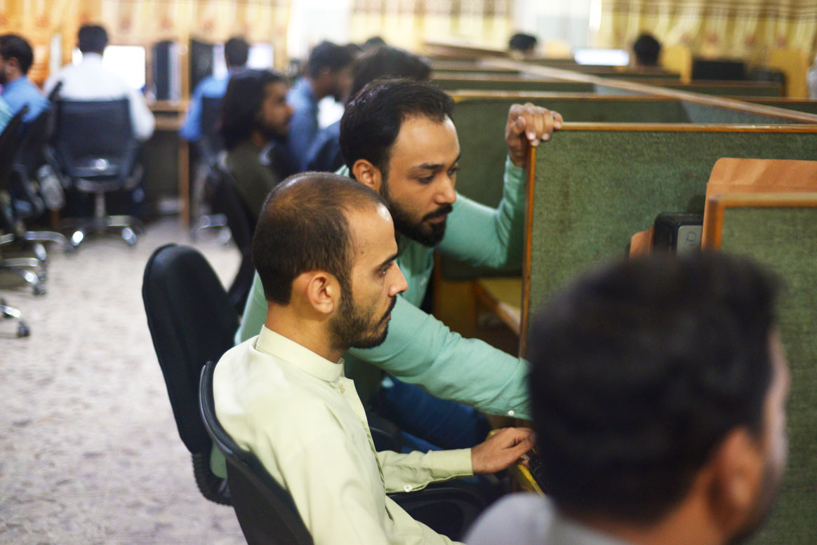Data experts poring over the latest numbers on the Integrated Disease Information Management System (IDIMS). © Mobeen Ansari