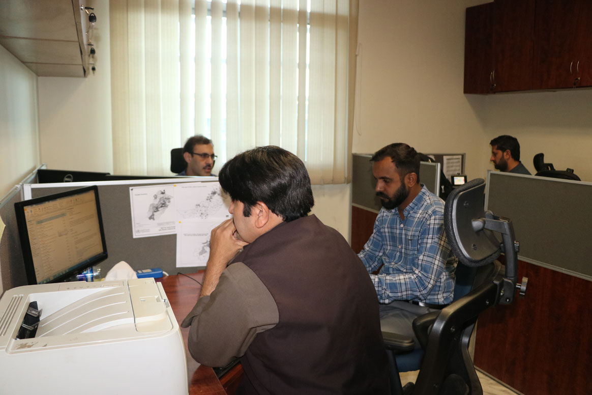 Data experts poring over the latest numbers on the Integrated Disease Information Management System (IDIMS). © Sadaf Kashif