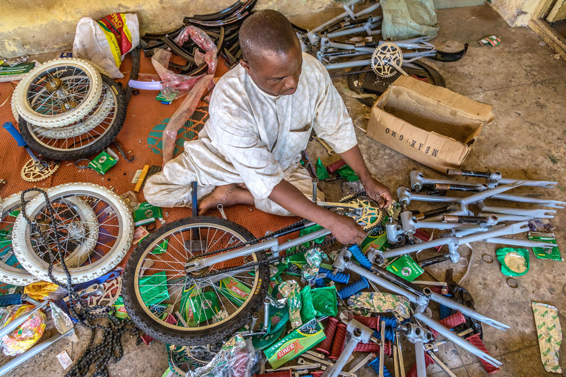 Isiaku Musa Maaji, a polio survivor himself, makes a living by building tricycles for people with mobility impairments. © Rotary International