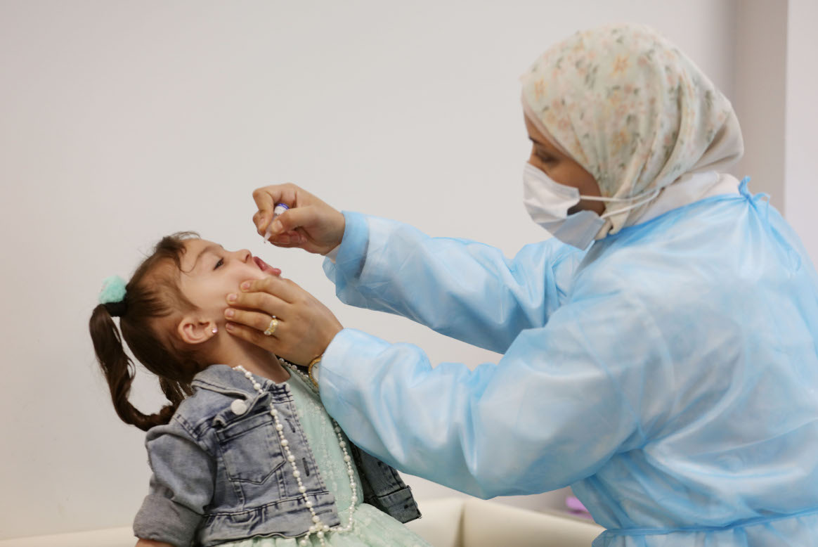 Three-year-old Yumna, niece of Samar al-Sheikh, receives her dose of OPV at Biddo UNRWA health facility on 18 May 2022. © WHO/occupied Palestinian territory