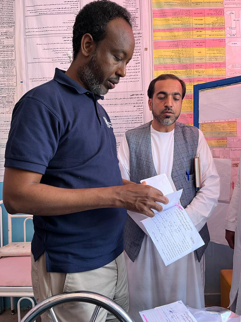 Going through referral notes. The 16-strong review team visited 67 districts in 25 of Afghanistan’s 34 provinces, checking documents and records, interviewing health workers and families of children with AFP, and reviewing guidelines and standard operating procedures. © WHO