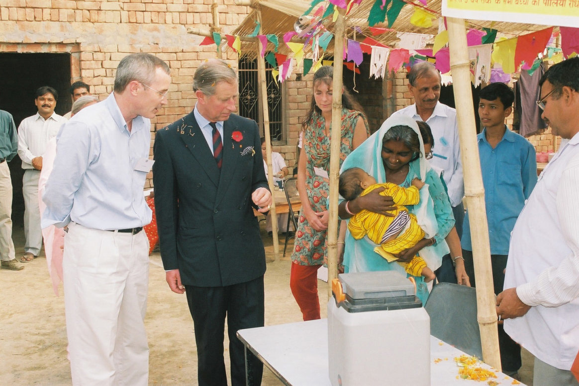 HRH Prince Charles observing the vaccination of children in a village on the outskirts of New Delhi. © Kiron Pasricha