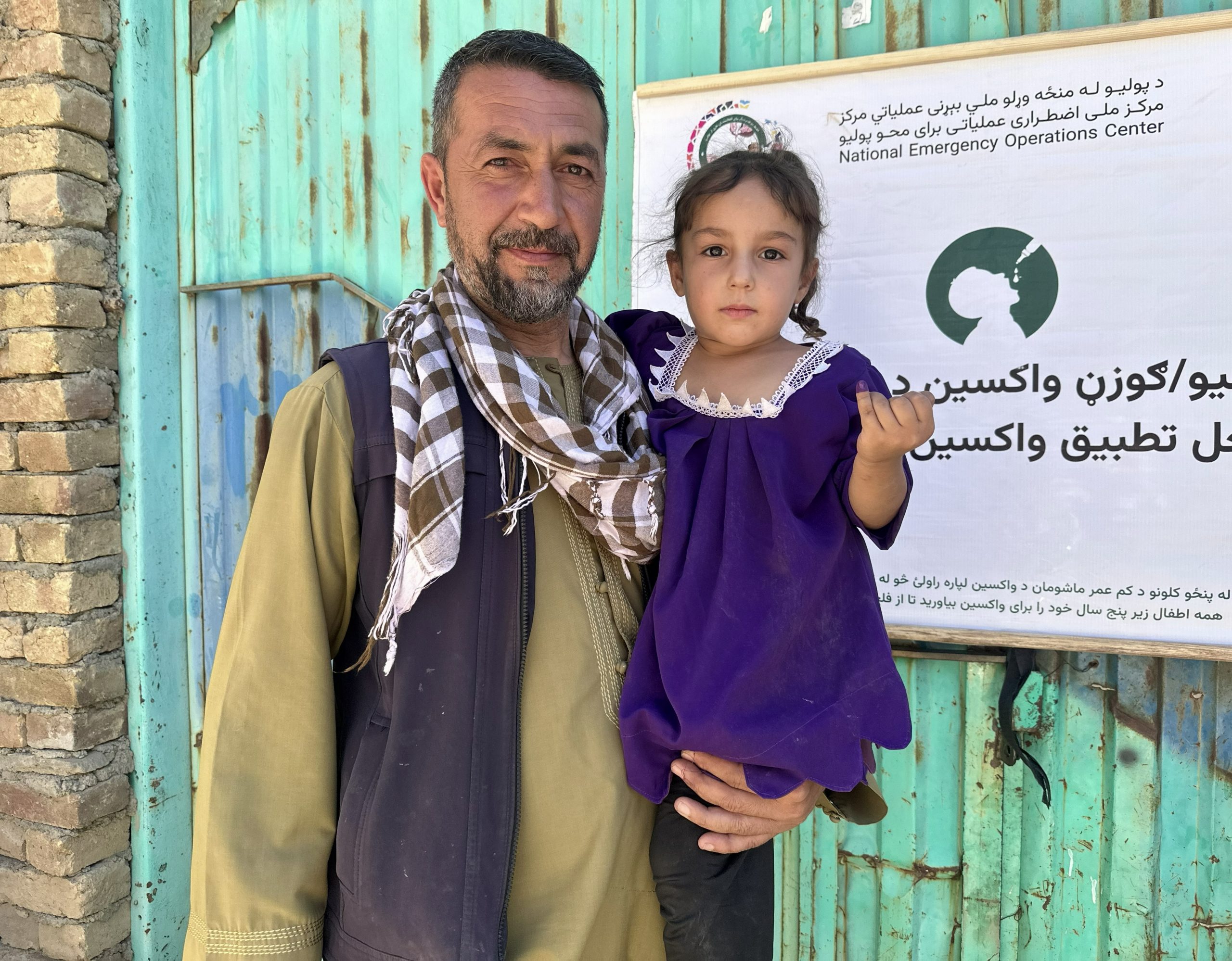 Mohammad Saber at a polio vaccination site after his child receives the polio vaccine. © WHO Afghanistan/Khesraw Omid Farooq